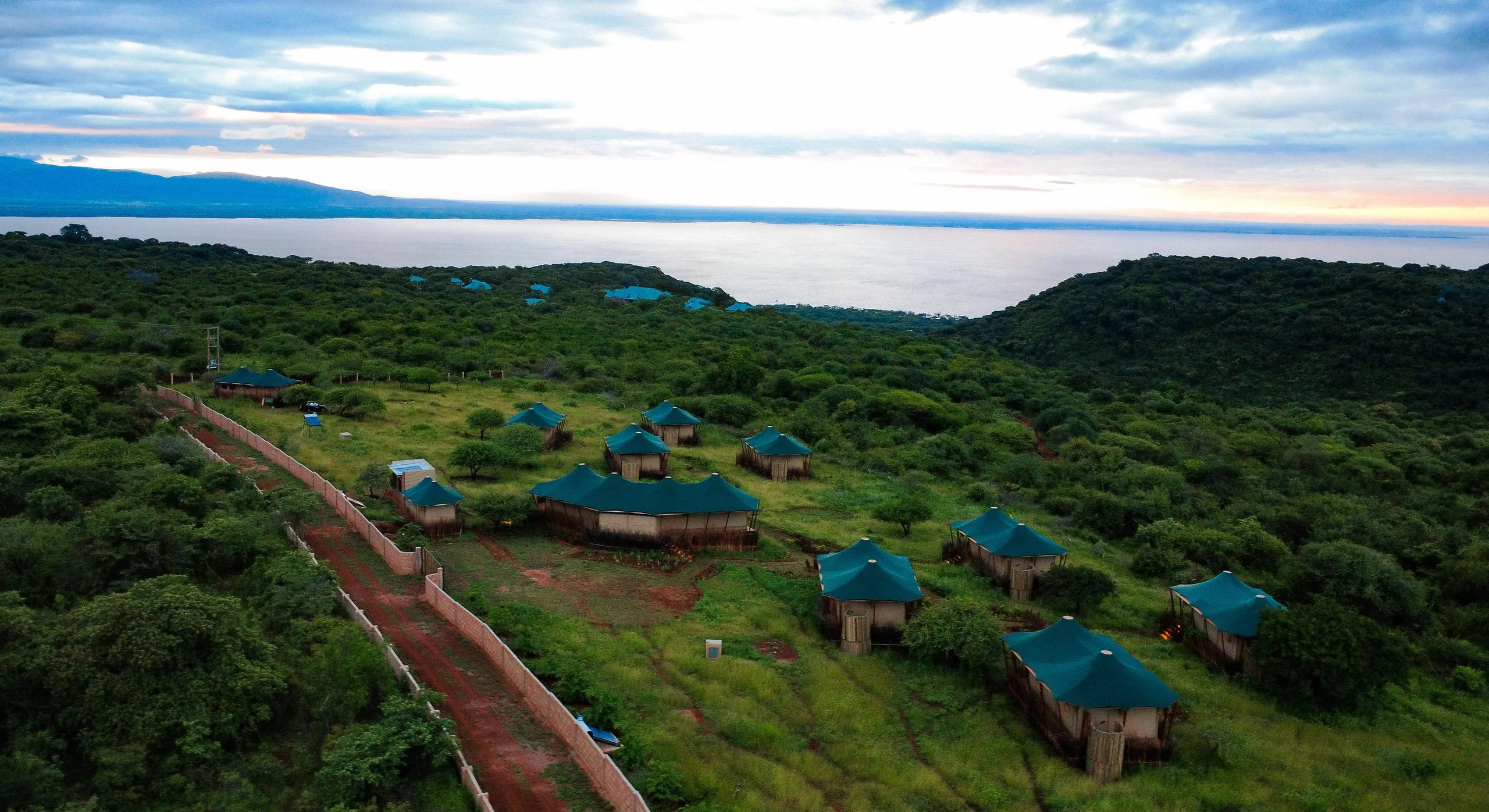 Aerial view of Touched by Nature lodge along the ridge with Lake Manyara and the Rift Valley beyond