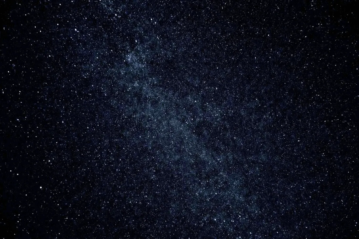 Night sky thick with stars over the ridge