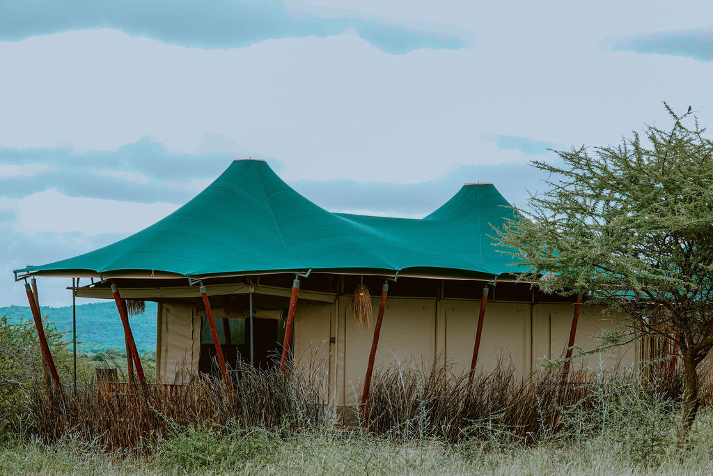The Ridge Tent — Conical canvas roof. Hand-cut teak floor. The lake straight ahead.