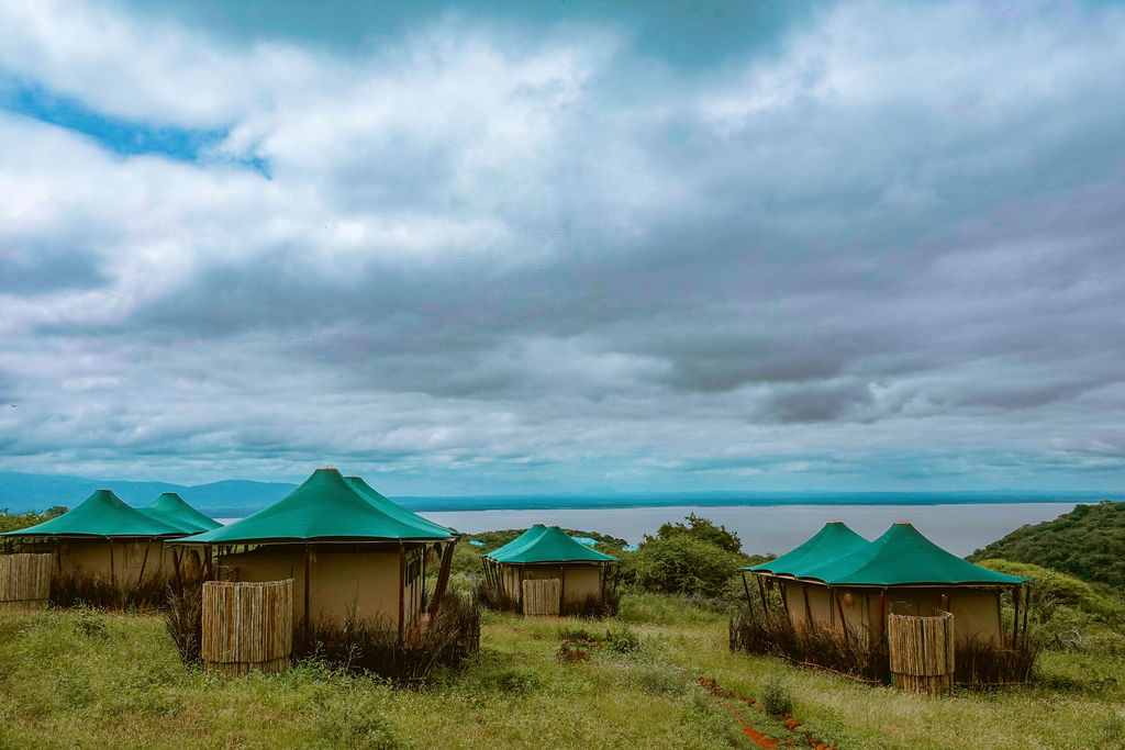 Row of tents along the ridge with Lake Manyara behind