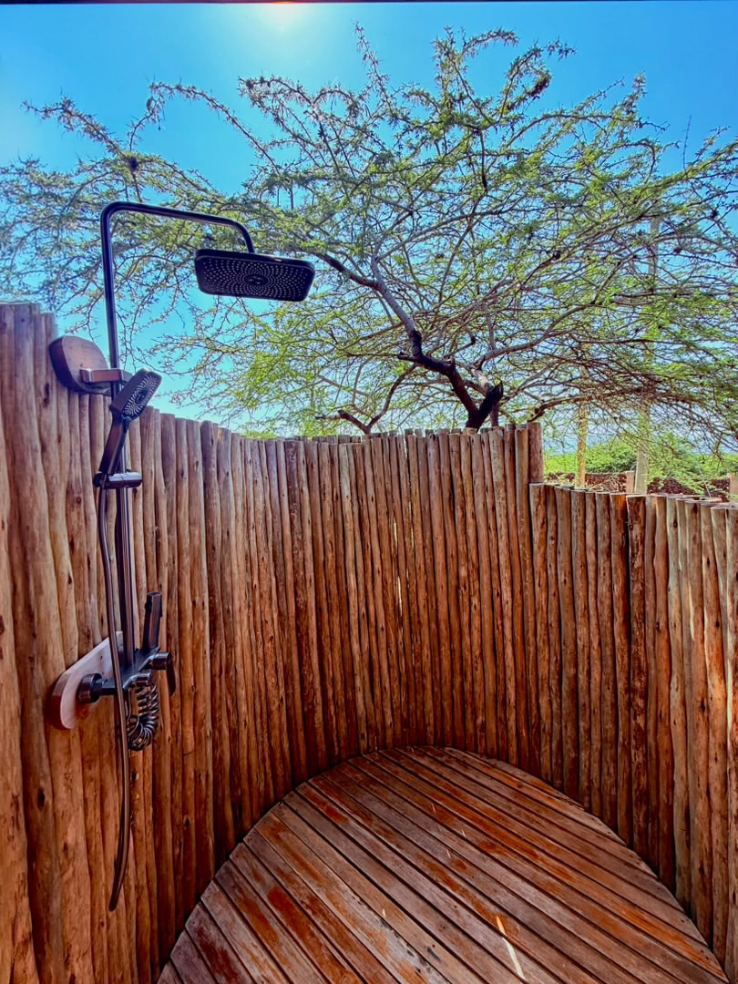 Outdoor rain shower under an acacia tree