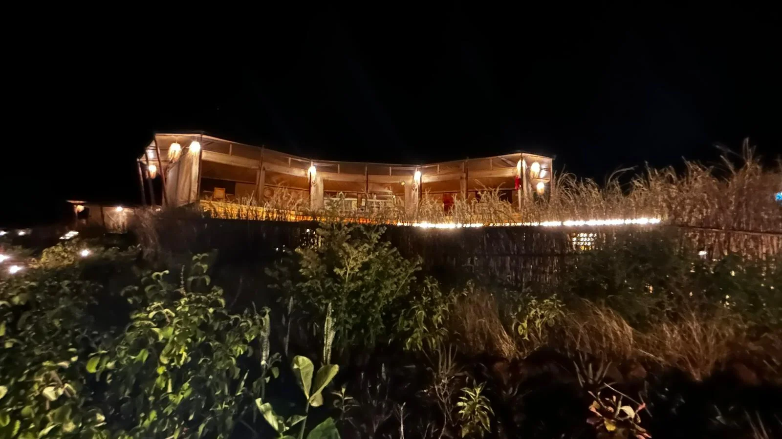 The lodge veranda illuminated for dinner at night